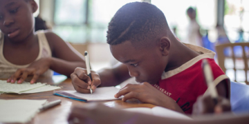 Boy writing on paper