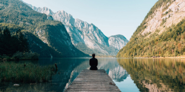 Man sitting on grey dock