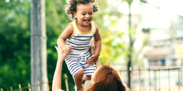 Woman lifting child